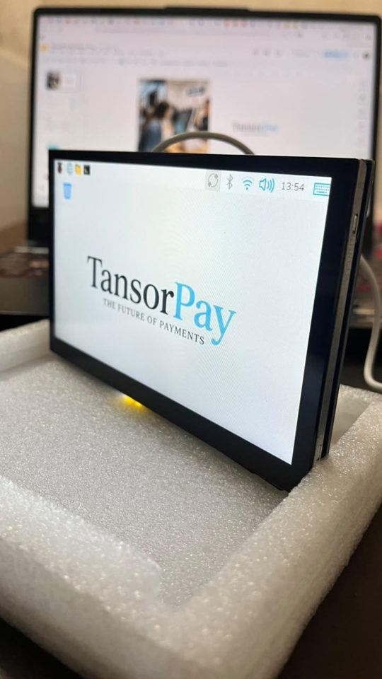 The TansorPay prototype terminal, a touchscreen on a development board, showing the TansorPay logo